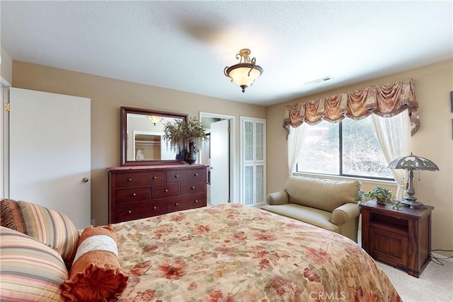 bedroom featuring light carpet and visible vents