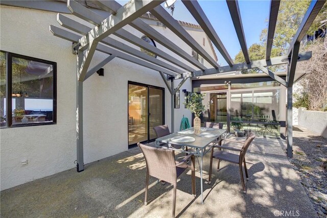 view of patio featuring a pergola and outdoor dining space