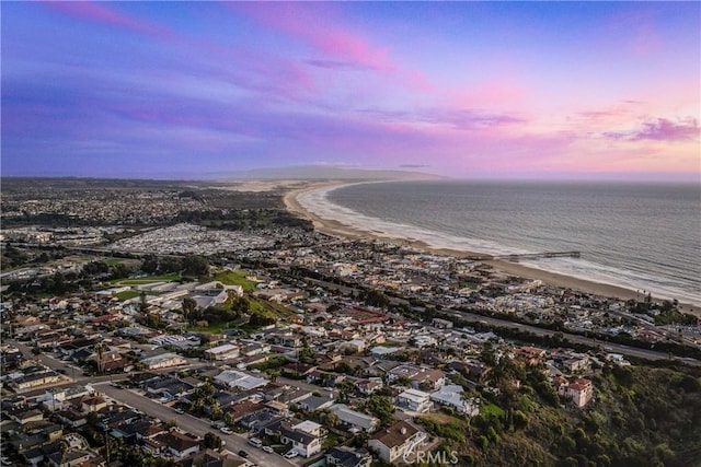 birds eye view of property with a beach view and a water view