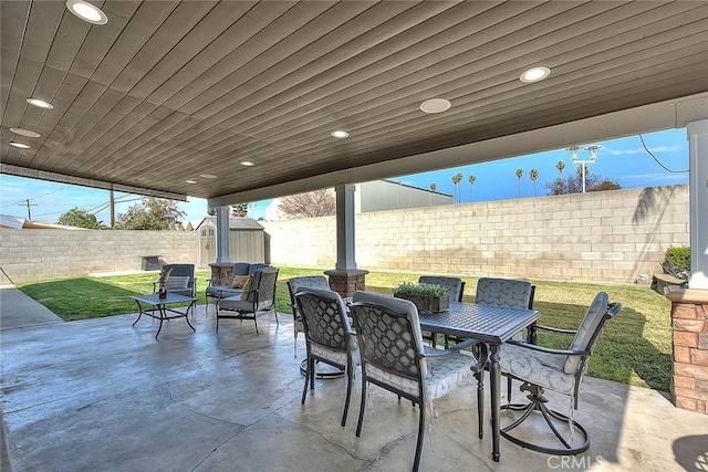 view of patio with a storage shed