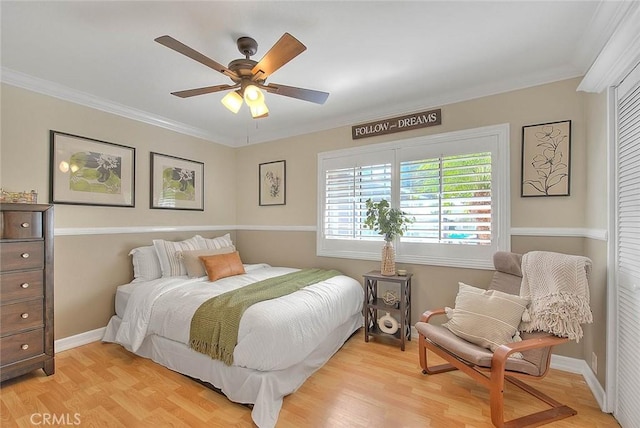 bedroom with crown molding, ceiling fan, a closet, and light hardwood / wood-style flooring