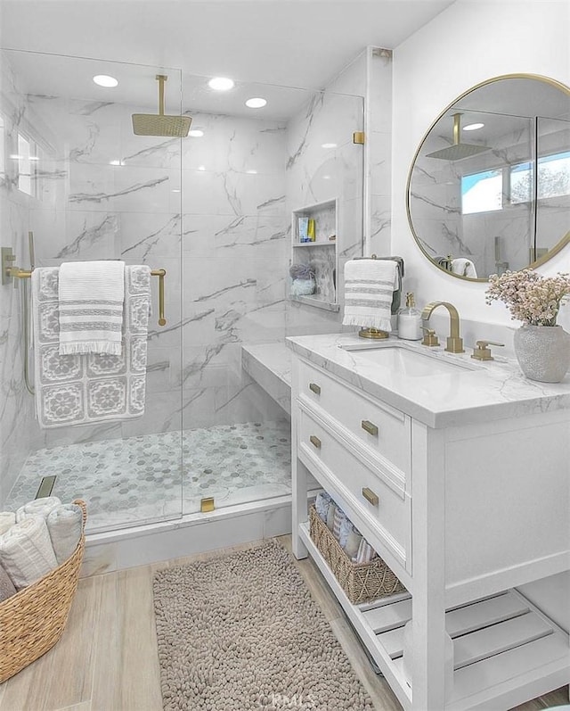 bathroom with vanity, hardwood / wood-style floors, and a shower with door