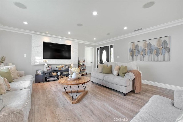 living room with crown molding and light wood-type flooring