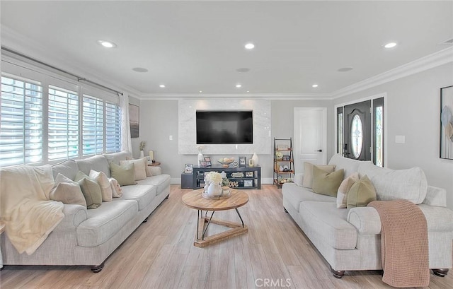 living room featuring ornamental molding and light wood-type flooring