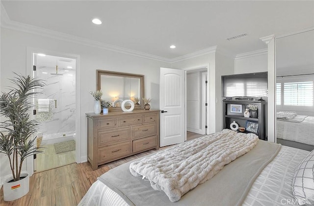 bedroom featuring ensuite bath, ornamental molding, and light hardwood / wood-style floors