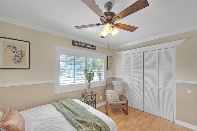 bedroom featuring crown molding, wood-type flooring, a closet, and ceiling fan