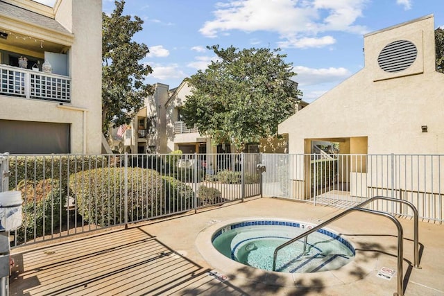 view of swimming pool with a hot tub and a patio area