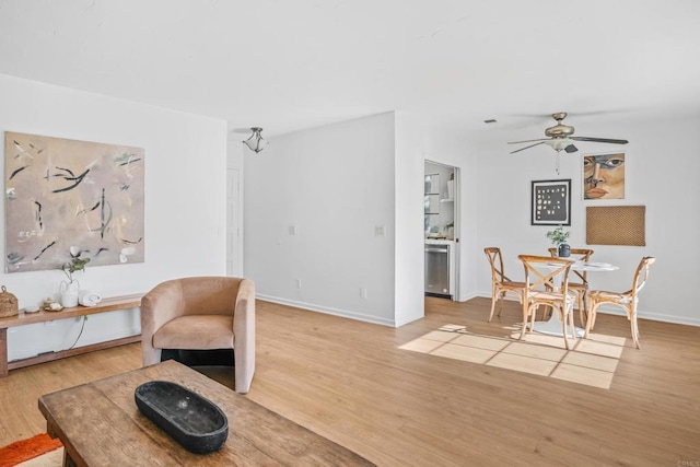 sitting room featuring ceiling fan and wood-type flooring