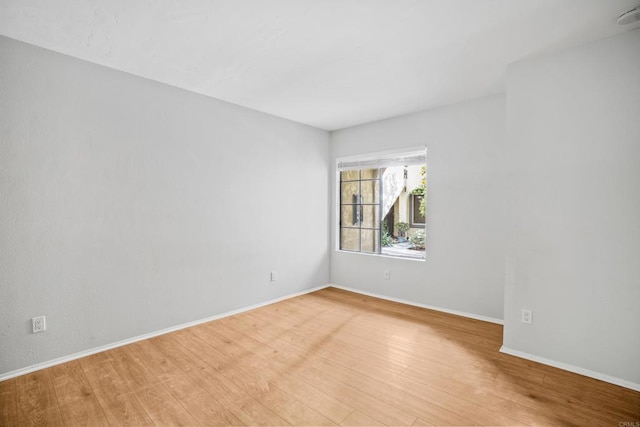 spare room with light hardwood / wood-style floors