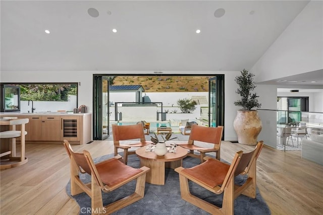 919 Sandcastle Dr, Corona Del Mar, CA 92625 - living area with light wood finished floors, wine cooler, high vaulted ceiling, and recessed lighting
