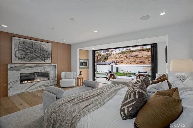 919 Sandcastle Dr, Corona Del Mar, CA 92625 - bedroom featuring recessed lighting, a premium fireplace, and wood finished floors