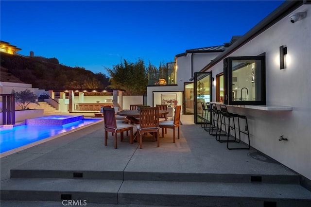 919 Sandcastle Dr, Corona Del Mar, CA 92625 - patio at twilight featuring outdoor dry bar, a fenced in pool, and an in ground hot tub