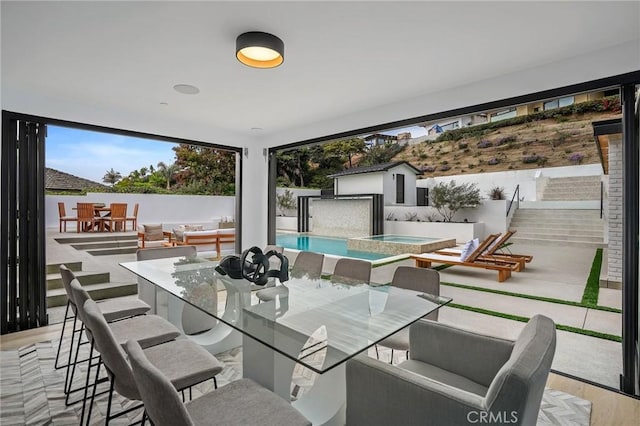 919 Sandcastle Dr, Corona Del Mar, CA 92625 - view of patio with an outdoor structure, outdoor dining space, a pool with connected hot tub, and fence
