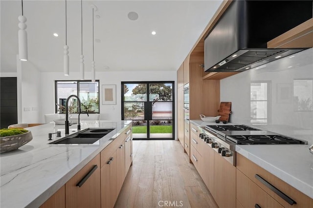919 Sandcastle Dr, Corona Del Mar, CA 92625 - kitchen featuring wall chimney exhaust hood, stainless steel gas cooktop, light wood-style flooring, a sink, and light stone counters
