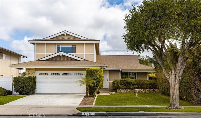 view of front of property featuring a garage and a front yard