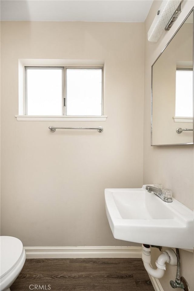 bathroom with hardwood / wood-style flooring, plenty of natural light, and toilet