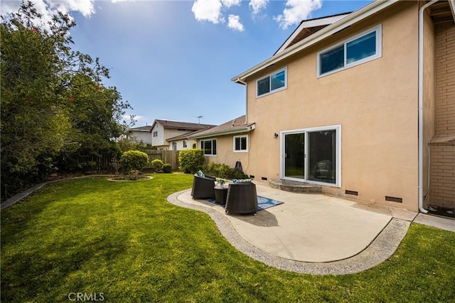 back of house with a yard and a patio