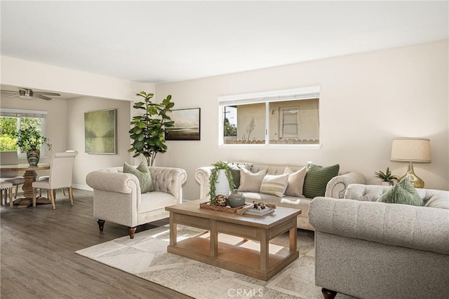 living room featuring hardwood / wood-style flooring and ceiling fan