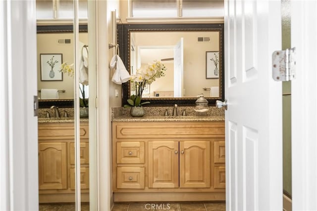 bathroom with vanity and tile patterned floors