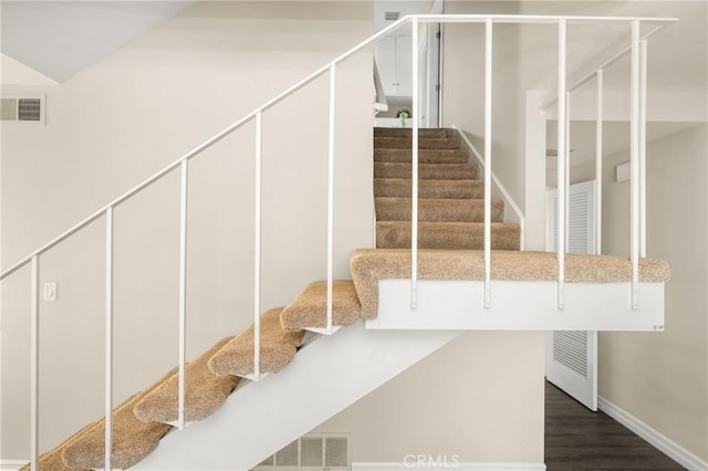 staircase featuring hardwood / wood-style flooring