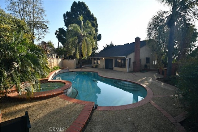 view of pool with an in ground hot tub and a patio