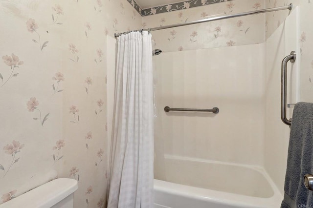 bathroom with shower / bath combination with curtain and toilet