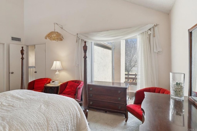 carpeted bedroom featuring lofted ceiling