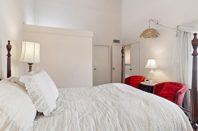 bedroom featuring a towering ceiling