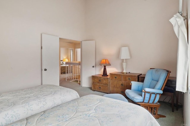 carpeted bedroom with a high ceiling