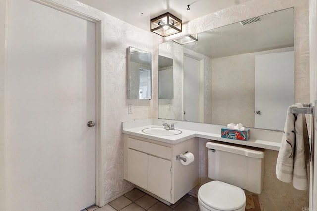 bathroom with vanity, tile patterned floors, and toilet