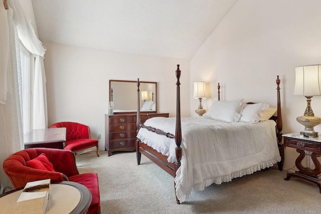 carpeted bedroom featuring lofted ceiling