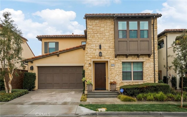 mediterranean / spanish home featuring driveway, a tile roof, and stucco siding