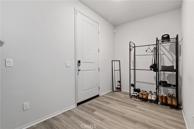 entryway featuring light wood-style flooring and baseboards