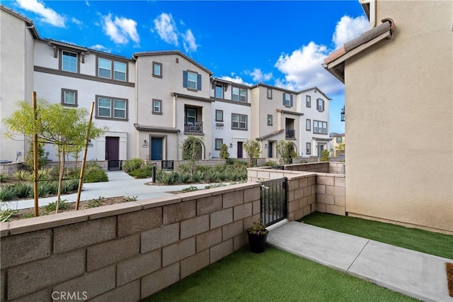 exterior space with a residential view, a gate, and fence