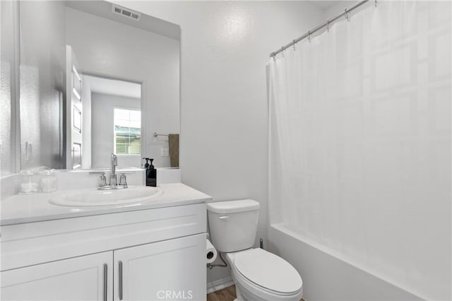 bathroom with toilet, shower / tub combo, vanity, and visible vents