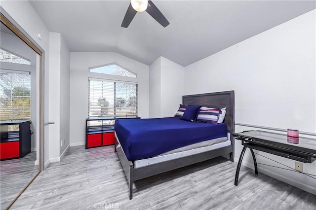 bedroom with multiple windows, light hardwood / wood-style flooring, and lofted ceiling