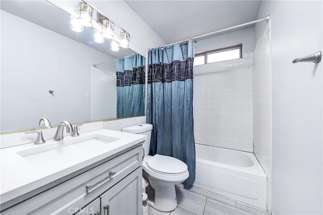 full bathroom featuring vanity, shower / tub combo, and toilet