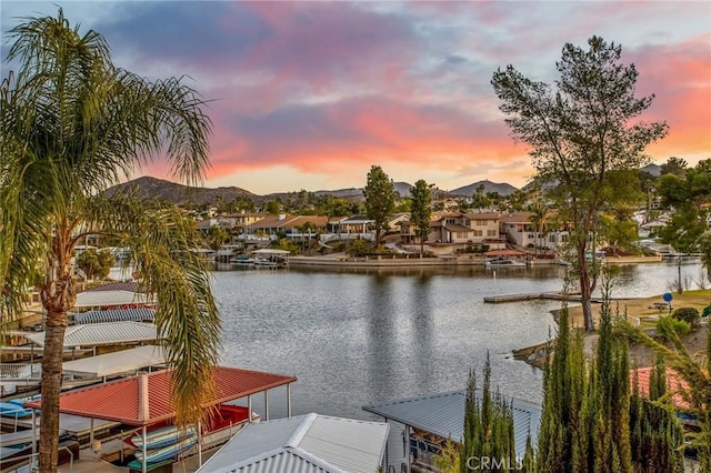 property view of water featuring a mountain view and a boat dock