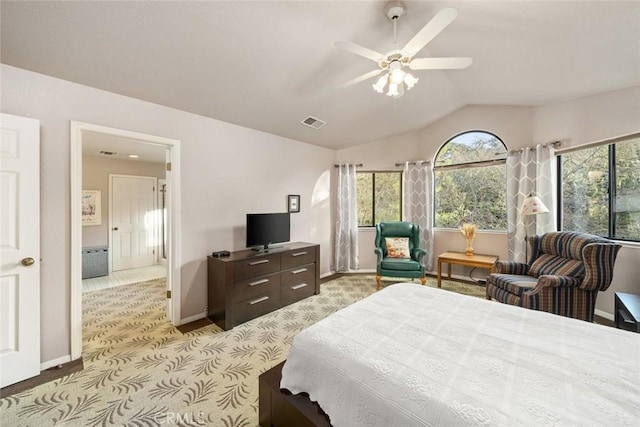 bedroom with multiple windows, lofted ceiling, light colored carpet, and visible vents