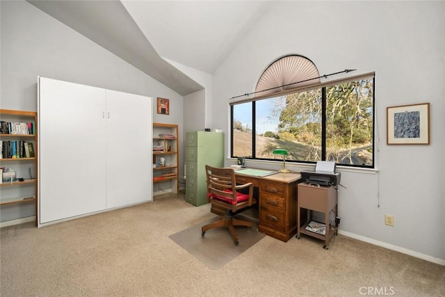 carpeted office featuring lofted ceiling