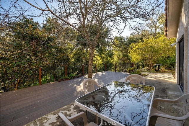 wooden terrace featuring outdoor dining area