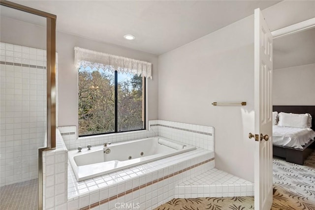 ensuite bathroom featuring tiled shower, a jetted tub, and ensuite bath