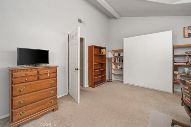 interior space featuring visible vents, baseboards, high vaulted ceiling, and light colored carpet