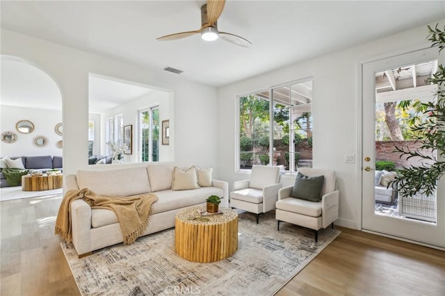 living room featuring hardwood / wood-style floors and ceiling fan