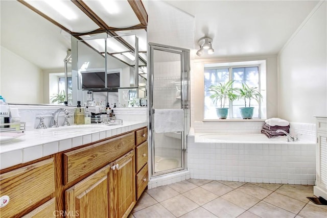 bathroom featuring tile patterned flooring, vaulted ceiling, independent shower and bath, and vanity