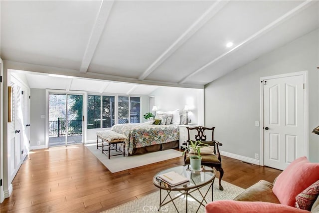 bedroom featuring vaulted ceiling with beams, access to outside, and light hardwood / wood-style floors