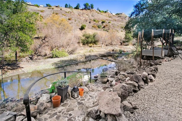 view of yard with a water and mountain view