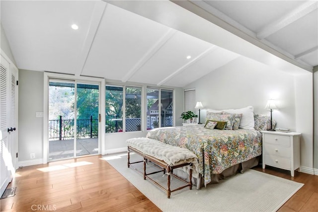 bedroom with access to exterior, wood-type flooring, and lofted ceiling with beams