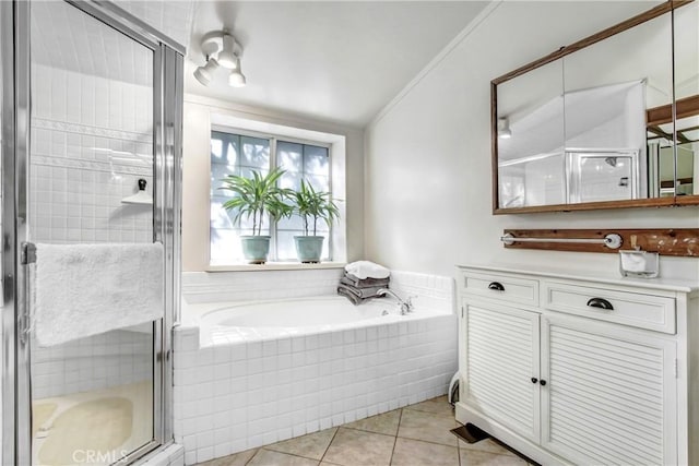 bathroom featuring tile patterned flooring and separate shower and tub