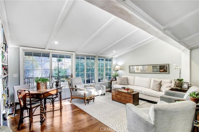 living room with wood-type flooring, vaulted ceiling with beams, and a wall of windows